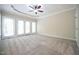 Spacious bedroom featuring a ceiling fan, neutral carpet and french doors at 14 Whit Ct, Angier, NC 27501