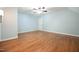 Bright bedroom features hardwood floors, a ceiling fan, and ample natural light at 14 Whit Ct, Angier, NC 27501