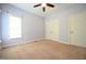 This is a simple carpeted bedroom with a ceiling fan, a double closet, and a sunny window at 14 Whit Ct, Angier, NC 27501