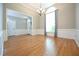 Bright dining room boasts hardwood floors, large windows, decorative moldings, and elegant chandelier at 14 Whit Ct, Angier, NC 27501