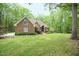 Charming brick home boasts lush landscaping and mature trees for a private, serene setting at 14 Whit Ct, Angier, NC 27501