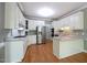 Modern kitchen features white cabinets, stainless steel appliances, and light countertops at 14 Whit Ct, Angier, NC 27501