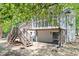 Spacious backyard with a wooden deck, screened-in porch, and a partially covered patio area at 1514 Goodwin Rd, Durham, NC 27712