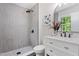 Modern bathroom with tiled walk-in shower, vanity, and stylish fixtures at 1514 Goodwin Rd, Durham, NC 27712