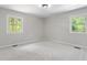 Inviting bedroom with neutral paint and carpeting and filled with natural light at 1514 Goodwin Rd, Durham, NC 27712