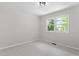 Cozy bedroom with neutral color palette with natural light from two windows at 1514 Goodwin Rd, Durham, NC 27712