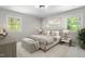 Comfortable bedroom featuring a plush bed, bench and neutral decor at 1514 Goodwin Rd, Durham, NC 27712