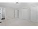 Bright bedroom with neutral carpet, and access to an en suite bathroom with dual closets at 1514 Goodwin Rd, Durham, NC 27712