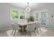 Bright dining area with modern lighting, dining table, and glass doors at 1514 Goodwin Rd, Durham, NC 27712