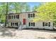 Inviting two-story home with a red front door and classic black shutters on the windows at 1514 Goodwin Rd, Durham, NC 27712