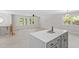 Open kitchen with grey island and white cabinets looking into the living area at 1514 Goodwin Rd, Durham, NC 27712