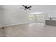 Spacious living room with light vinyl flooring, modern fan, and convenient access to the kitchen at 1514 Goodwin Rd, Durham, NC 27712