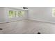 Living room with light, neutral walls and flooring and an abundance of natural light at 1514 Goodwin Rd, Durham, NC 27712
