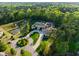 Beautiful estate aerial highlighting the elegant design, picturesque pond with fountain, and mature trees at 16 Portofino Pl, Durham, NC 27707