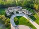 Stunning aerial view of an estate home with circular driveway, lush landscaping, and attached garages at 16 Portofino Pl, Durham, NC 27707