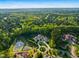 Aerial view of luxurious estate featuring a fountain pond, landscaped grounds, and stately architecture at 16 Portofino Pl, Durham, NC 27707