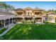 Spacious backyard featuring a manicured lawn and an expansive outdoor living and entertaining space at 16 Portofino Pl, Durham, NC 27707