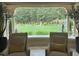 Inviting sitting area with panoramic view of the landscaped backyard and fountain at 16 Portofino Pl, Durham, NC 27707