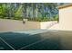 Private basketball court area featuring a full court, privacy walls, and staircase access at 16 Portofino Pl, Durham, NC 27707
