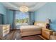 Bedroom featuring hardwood floors, a large window with neighborhood views, and elegant decor at 16 Portofino Pl, Durham, NC 27707
