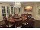 Well lit dining room with a chandelier and custom table and chairs at 16 Portofino Pl, Durham, NC 27707