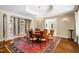 Elegant dining room with large windows, chandelier, and custom table at 16 Portofino Pl, Durham, NC 27707