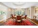 Elegant dining room with a chandelier, large dining table, and views of the backyard at 16 Portofino Pl, Durham, NC 27707