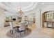 Elegant dining room with coffered ceiling, chandelier, and views into the kitchen at 16 Portofino Pl, Durham, NC 27707