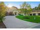 Beautiful home showcasing manicured lawns, mature trees, and a grand entrance with meticulous landscaping at 16 Portofino Pl, Durham, NC 27707