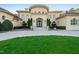 Beautiful home exterior featuring manicured lawn, front door and a circular driveway at 16 Portofino Pl, Durham, NC 27707