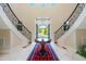 Elegant foyer featuring marble floors, a center table, and a dual staircase with decorative railings at 16 Portofino Pl, Durham, NC 27707