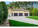 Spacious three-car garage, with neutral exterior and driveway, offering ample parking and storage at 16 Portofino Pl, Durham, NC 27707
