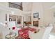 The great room boasts soaring ceilings, a fireplace, a grand piano, and elegant details at 16 Portofino Pl, Durham, NC 27707