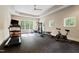 Bright home gym with ceiling fan, natural light, and a variety of fitness equipment at 16 Portofino Pl, Durham, NC 27707