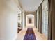 Long hallway with archway doors and french doors leading to outdoor spaces at 16 Portofino Pl, Durham, NC 27707