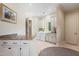 Well-lit laundry room with granite countertop, white cabinets, modern washer and dryer at 16 Portofino Pl, Durham, NC 27707