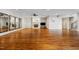 Open concept living room featuring hardwood floors, a fireplace, and multiple mirrors at 16 Portofino Pl, Durham, NC 27707