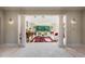 Elegant living room featuring grand columns, travertine floors, decorative rug, and bright light at 16 Portofino Pl, Durham, NC 27707
