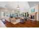 Spacious living room with tray ceiling, fireplace, and hardwood floors at 16 Portofino Pl, Durham, NC 27707