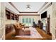 Living room with built-in bookshelves, fireplace, and French doors to the backyard at 16 Portofino Pl, Durham, NC 27707