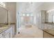 Luxurious bathroom with double vanities, a soaking tub, arched shower entrances and designer lighting at 16 Portofino Pl, Durham, NC 27707