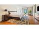 This main bedroom has a large bed, a sitting area, and an ensuite bath at 16 Portofino Pl, Durham, NC 27707