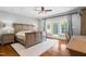 Bright and airy main bedroom featuring natural light, ceiling fan, and hardwood floors at 16 Portofino Pl, Durham, NC 27707