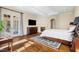 Spacious main bedroom features a fireplace, flat screen TV, and access to a private balcony at 16 Portofino Pl, Durham, NC 27707