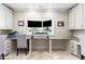 A well-lit home office is equipped with built-in desk and storage at 16 Portofino Pl, Durham, NC 27707