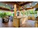 Outdoor kitchen area complete with granite counters and high-end grill at 16 Portofino Pl, Durham, NC 27707