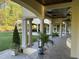 Lovely covered patio with columns, tiled floor, and view of backyard at 16 Portofino Pl, Durham, NC 27707