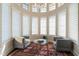Bright sitting area with a round glass table, chairs and many windows offering natural light at 16 Portofino Pl, Durham, NC 27707