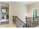 Elegant staircase with wrought iron railing and lots of natural light at 16 Portofino Pl, Durham, NC 27707
