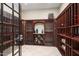 Home wine cellar with wooden racks, climate control, and glass door at 16 Portofino Pl, Durham, NC 27707